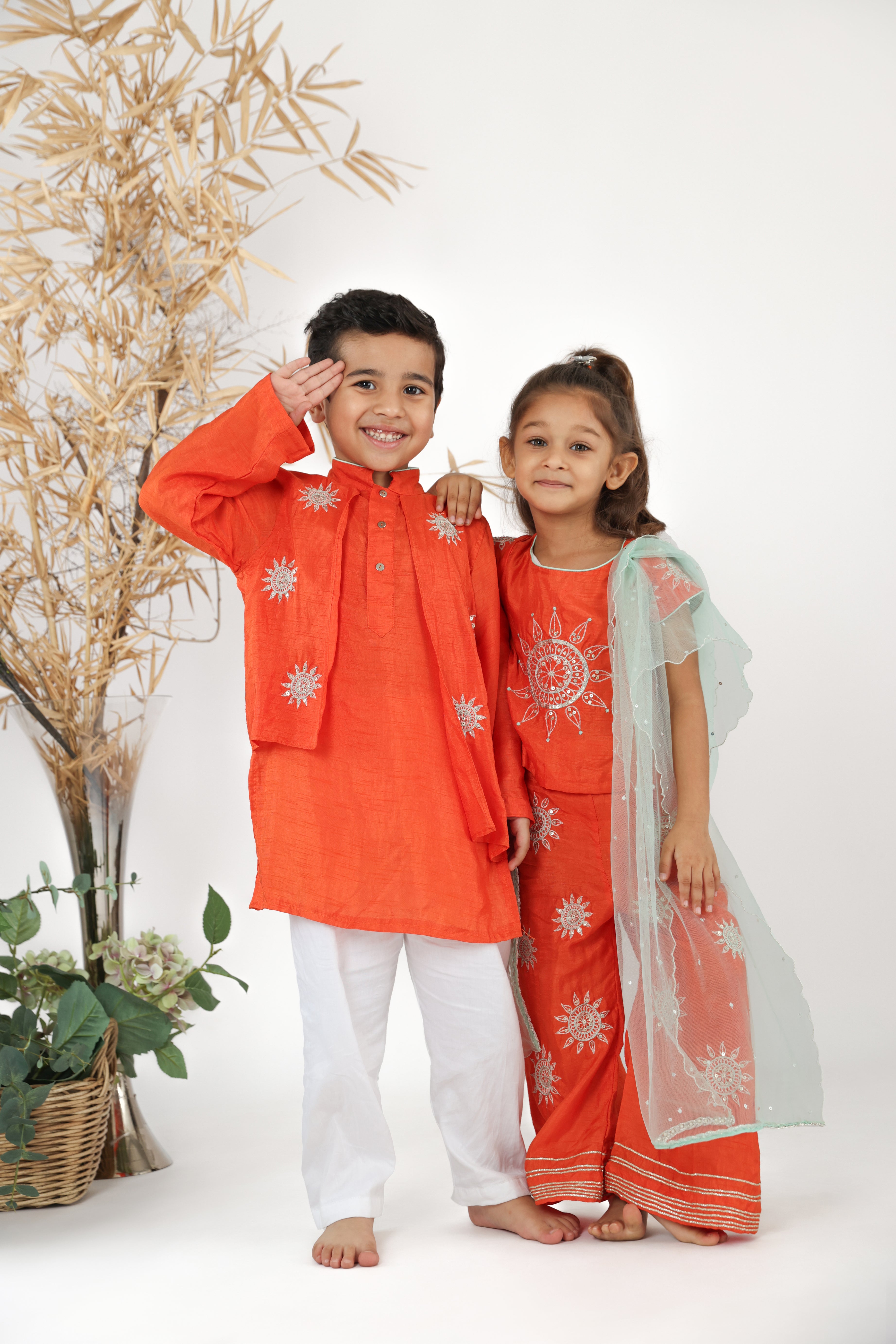 Twinning in Traditional Orange Silk Top and Pants with Sea Green Dupatta and Orange Kurta and White Pyjama